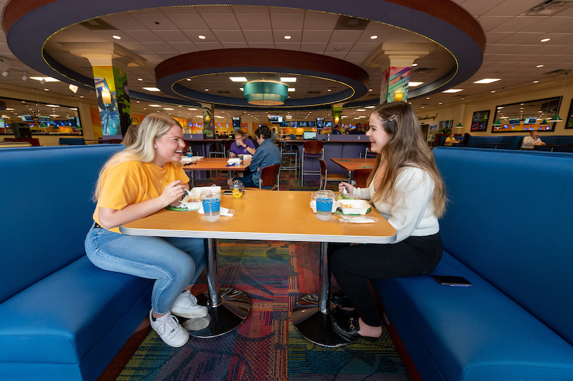 Students sitting at booth in theSlane Cafe