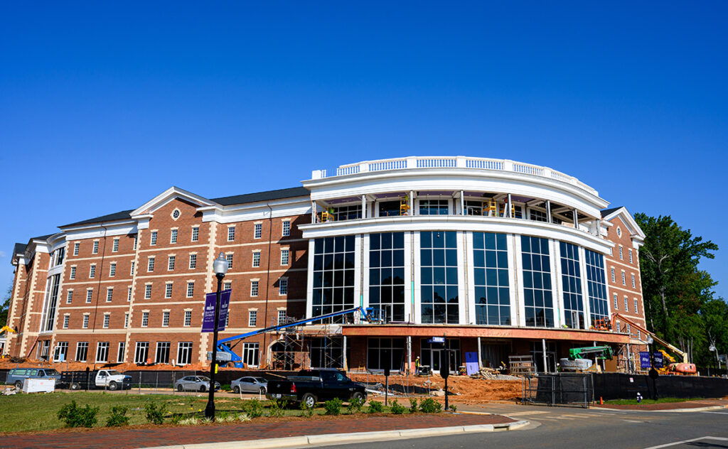 Panther Commons, pictured in a recent photo, has opened on campus as the newest housing complex and student center. The 200,000-square-foot building stands five stories tall to house a total of 400 graduate and undergraduate students. All rooms are ready for move in, and final construction on the exterior and new retail options will be complete in September. 