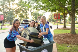 Three student volunteers helped unload vehicles and move new students into their residence halls during HPU’s Move-In Weekend in August.