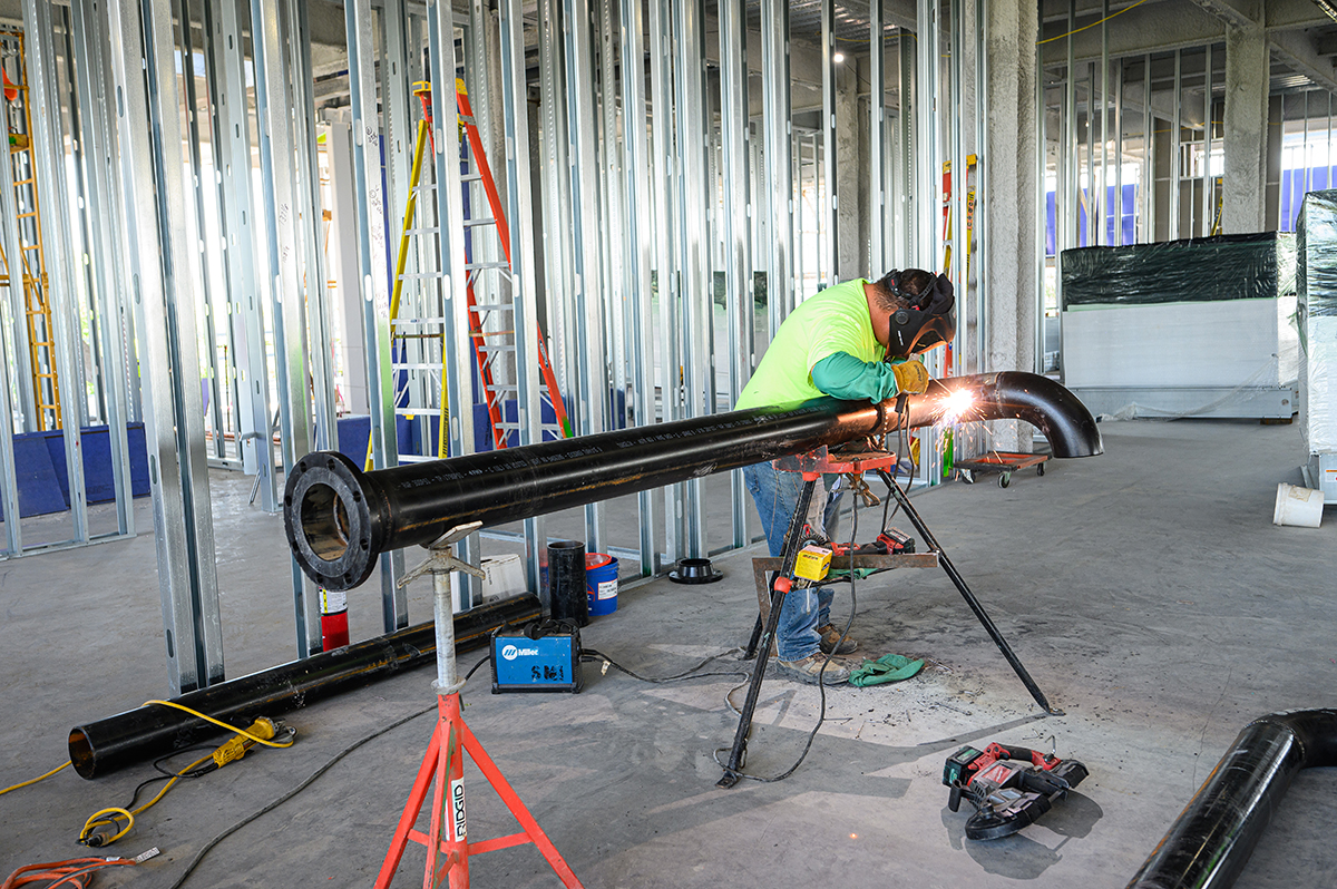 Approximately 100-200 workers are on site daily and making progress on the library. Pictured was a welder working on a pipe.