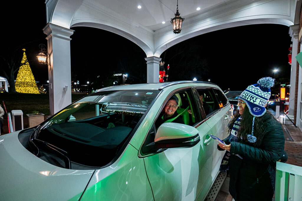 HPU staff member Autumn Wright greeted a community member as he entered campus for the Christmas Drive on Dec. 22, 2025.
