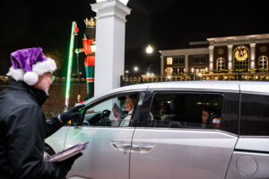 HPU faculty and staff volunteers help make the event possible. Pictured is Andy Brehm, HPU’s director of corporate relations, interacting with a group of guests as they left campus at the end of the Christmas Drive.