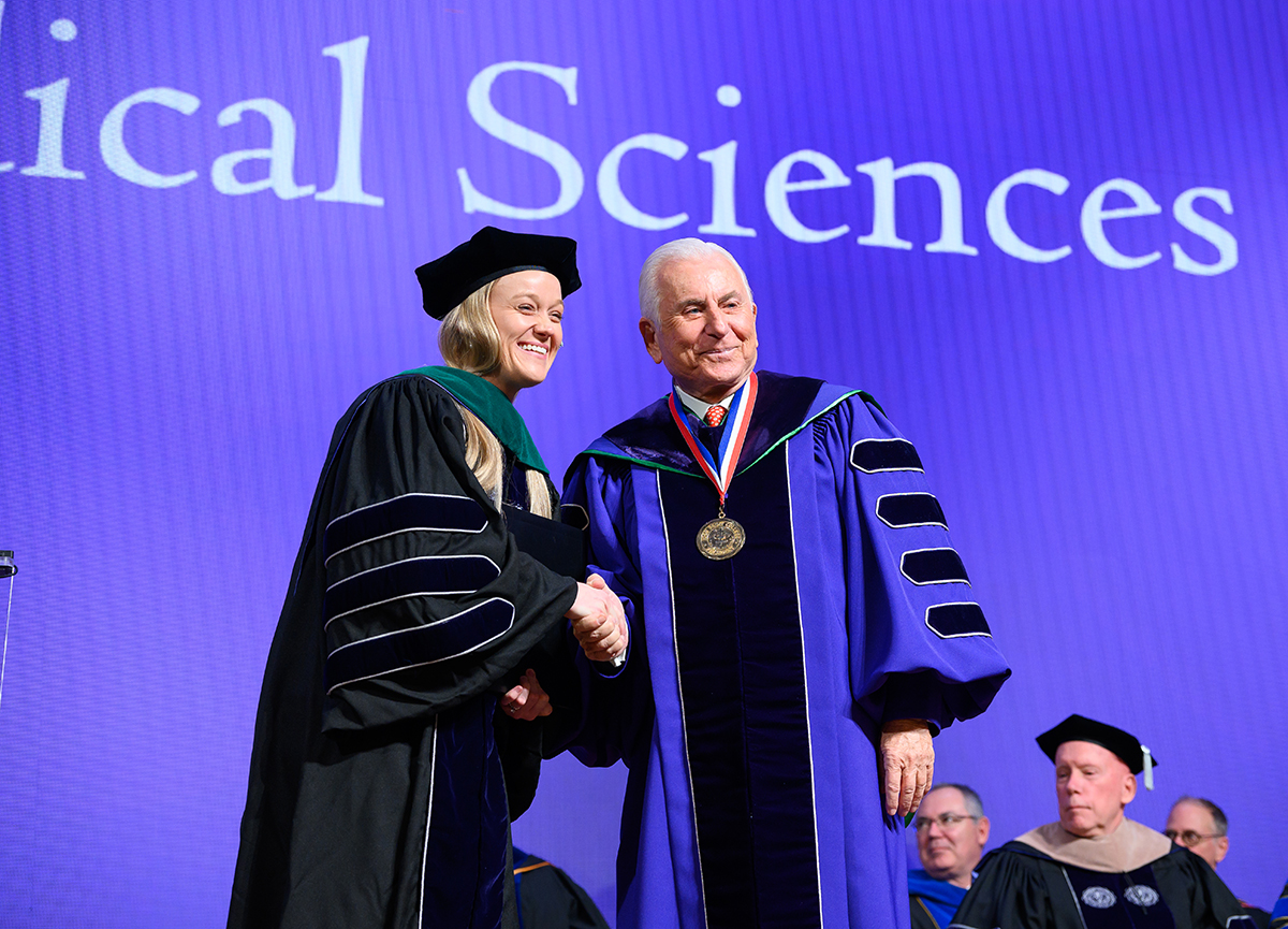 A graduate student smiled as she shook hands with Qubein after she received her Doctor of Medical Sciences degree.