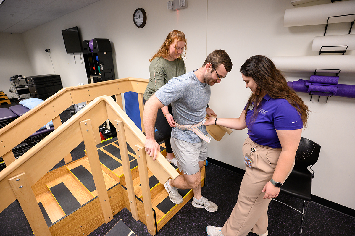 Pictured from left was DPT student Lindsey Van Der Stad as she helped classmate Dakota Sheppard down a set of stairs at HPU’s Pro Bono Physical Therapy Clinic in the city of High Point. Hannah Engels, another DPT student, assisted Sheppard at the bottom of the stairs. All three students will graduate in 2027.
