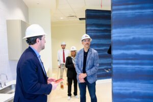 Cain, left, gave Kessler a tour of the three-story, 77,500-square-foot building that will be the dental school’s permanent home when it opens this summer. They walked through the space that will be a fully functional dental office.