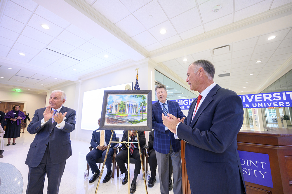 During the ceremony, Dr. Qubein presented Dr. Rick Workman with a painting of the new dental school building, which the university had commissioned an artist to create.