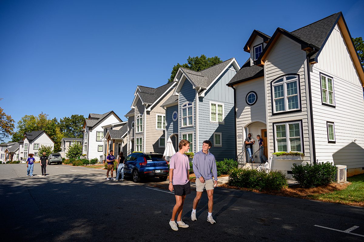 HPU’s campus also features a neighborhood of tiny homes for students. A group of students interacted outside a row of tiny homes, each one 500 square feet.