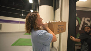 Khara Mungo, HPU’s catering director, carried a box of bottled water that another staff members loaded onto a truck.