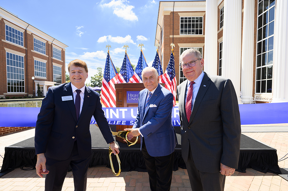 High Point University held a ribbon-cutting ceremony on Sept. 11 to celebrate the grand opening of the new building for the Kenneth F. Kahn School of Law. Pictured from left are Mark Martin, the law school’s founding dean, holding a pair of scissors with HPU President Nido Qubein as HPU Provost Daniel Erb stood next to them.