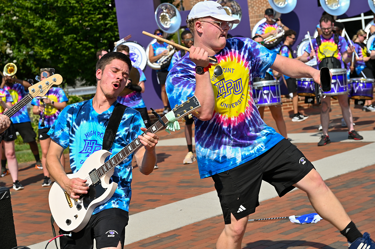 The HPU Marching Panthers performed for the Class of 2030 as new students and their families arrived on campus. A guitar player in the marching band performed as another member banged on a cowbell.