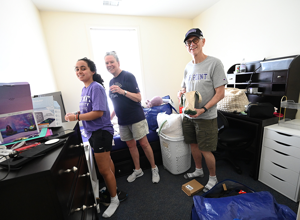 Phoebe Carlson, left, had help from her parents Julie and Bud as she unpacked her items inside her new dorm room. The family is from St. Louis, Missouri.