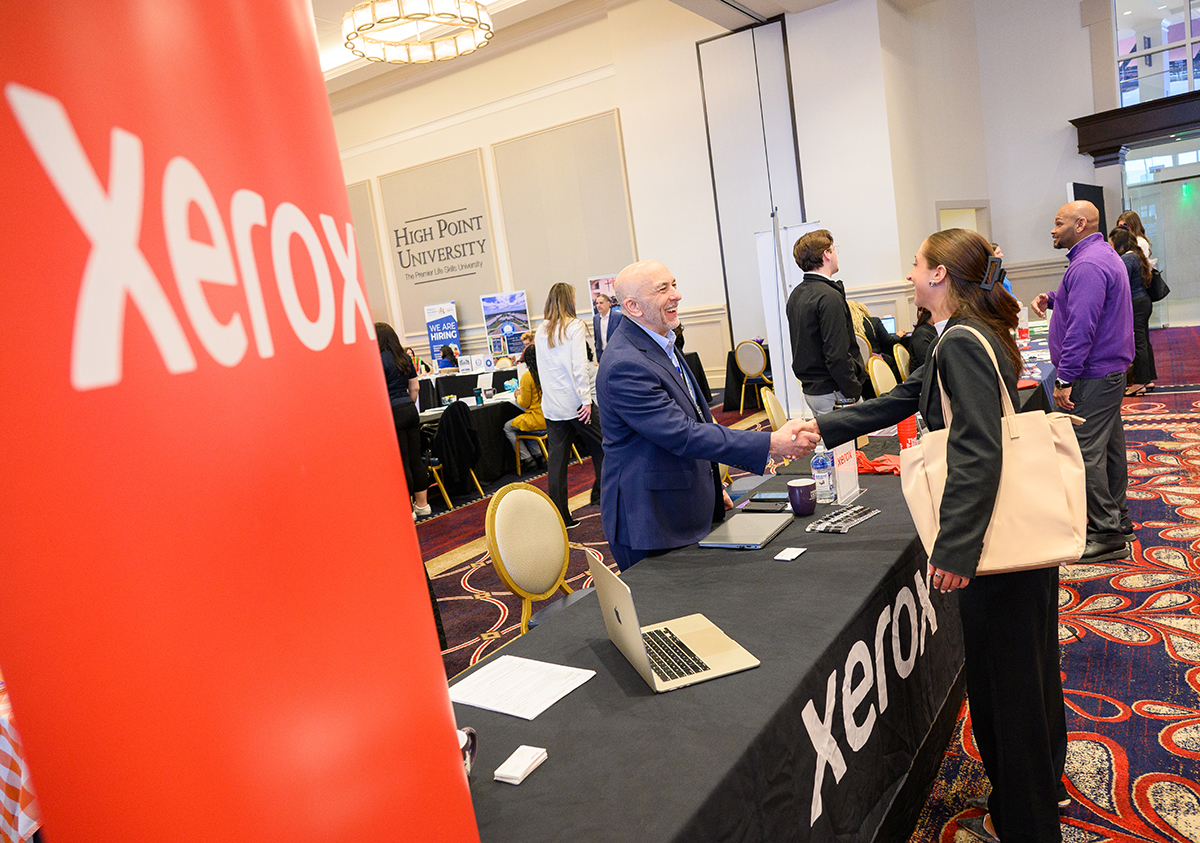 Paul DeProfio, Xerox vice president of sales for the Carolinas, greeted Amelia Courbron, a junior finance major from Stratford, Connecticut, during HPU's annual Life Skills Career Summit at the Nido and Mariana Qubein Arena and Conference Center on Feb. 10.