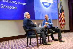 Marc Randolph laughed as he answered questions from Dr. Nido Qubein in front of a large audience of students and community members.