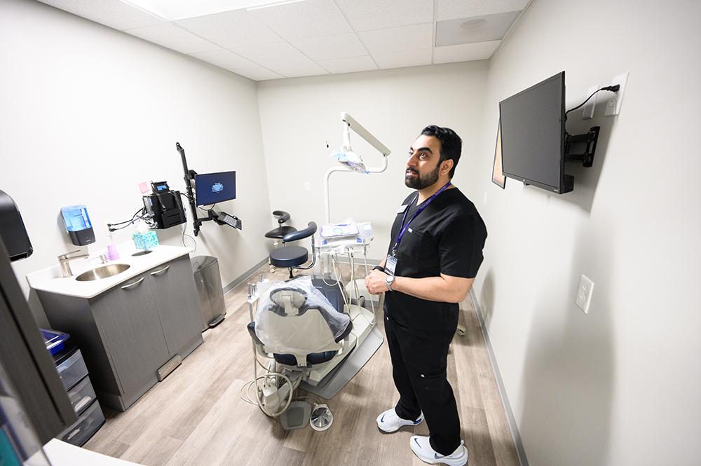 Dr. Arslan Lashar, a clinical assistant professor in the Workman School of Dental, views a space inside HPU Health Plaza Dental while getting a tour of the new facility.