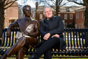 Graham sat on a bench next to a statue of his father, American evangelist Billy Graham, during a recent visit to HPU’s campus.
