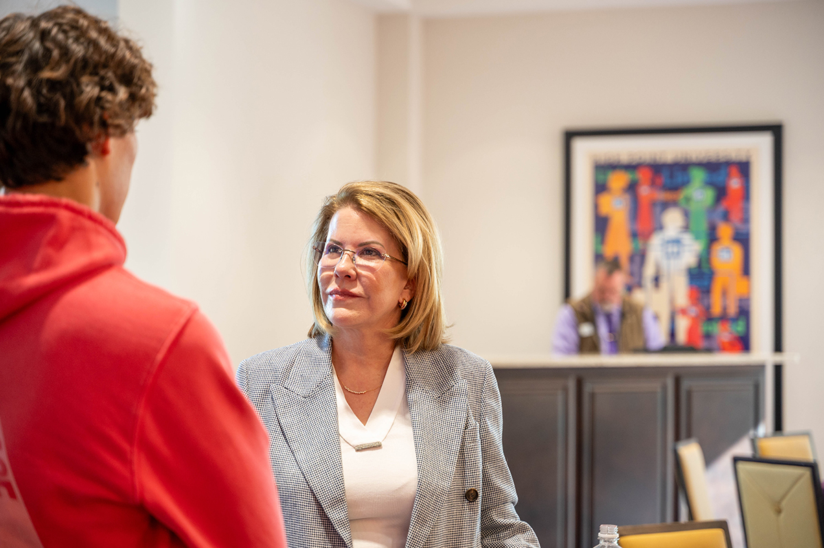 Sue Downes listened to a student while meeting with him one-on-one after her talk in Cottrell Hall.