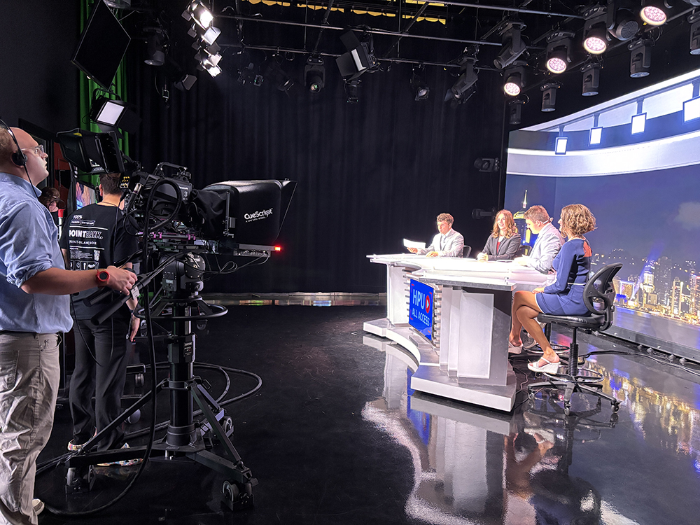 Pictured from left is HPU student Tucker Newton as he worked as a camera operator while framing up HPU Vision hosts Nick Allen, HPU alumna Lauren Schena, Jake Vesey and Marisa Janis.
