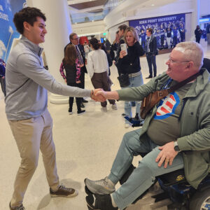 HPU freshman Max Mody, who’s a member of the Kappa Alpha Order, shook hands with Dr. Lewis Scott Oatman, a retired U.S. Air Force technical sergeant, during the presentation on Feb. 8.
