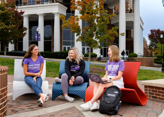 Emerson Hecker, left, is shown laughing with friends on HPU's campus.