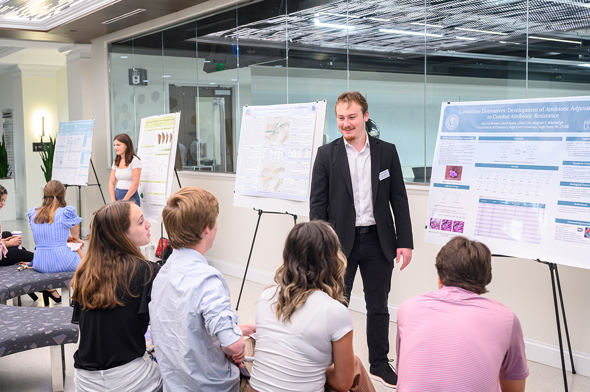 Burton Brewer, a sophomore chemistry major from Columbia, South Carolina, presented his poster to other students and discussed his research on antibiotic-resistant bacteria.