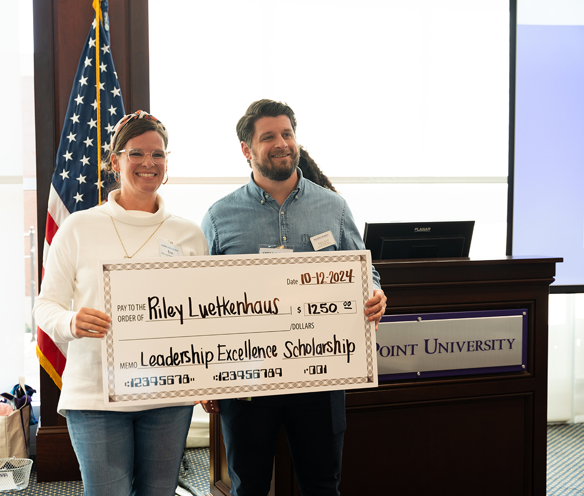 Dr. Erin Jacobson, left, presented the APTANC leadership Excellence Scholarship to Riley Luetkenhaus, a third-year DPT student.