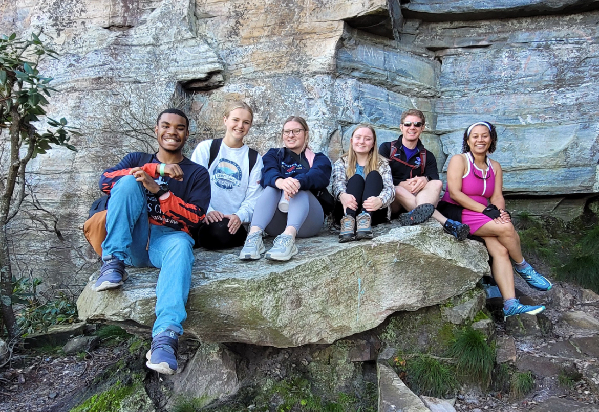 ) HPU students Benjamin Carver, left, Emma Higgins, Haley Hedrick and Cassidy Brake posed for a photo on a boulder with Bradley Taylor and Rev. Andria Williamson.