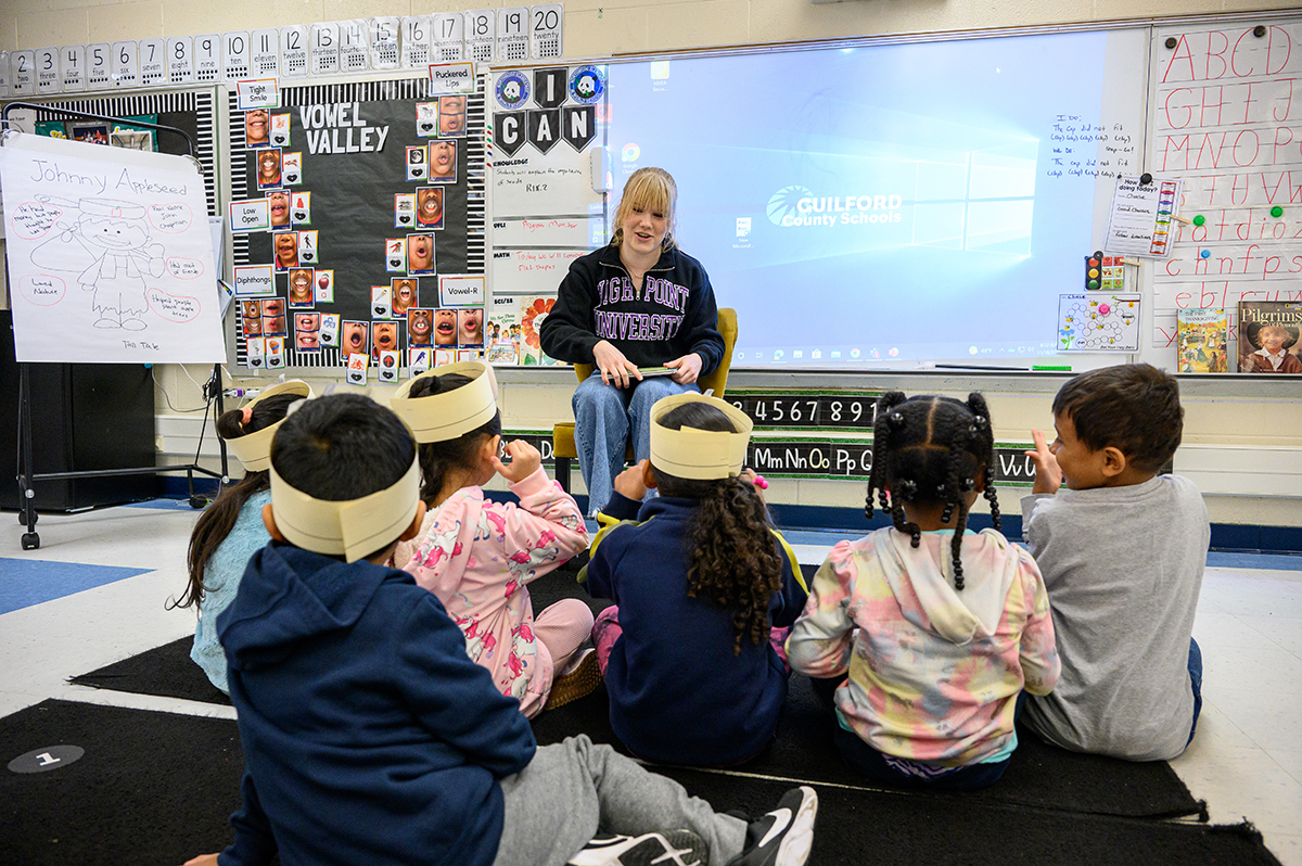 Pictured reading to kindergarten students was Jill Buckley, a freshman Education Fellow and international student who is originally from Grand Junction, Colorado. 