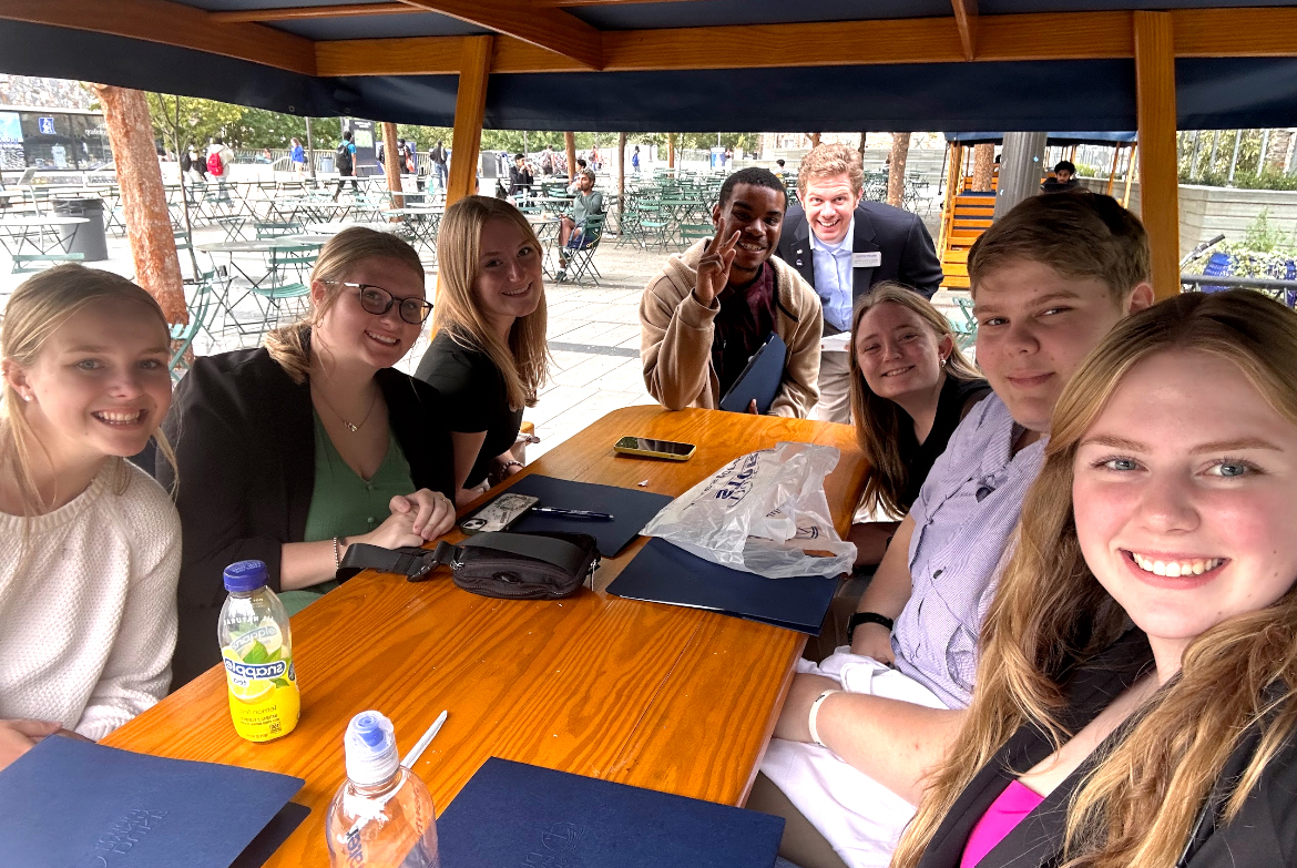 Pictured from left are Emma Higgins, Haley Hedrick, Shelby Rosenhahn, Benjamin Carver, Bradley Taylor, Cassidy Brake, Meigs Roberts and Riley Rickman while seated at a table.