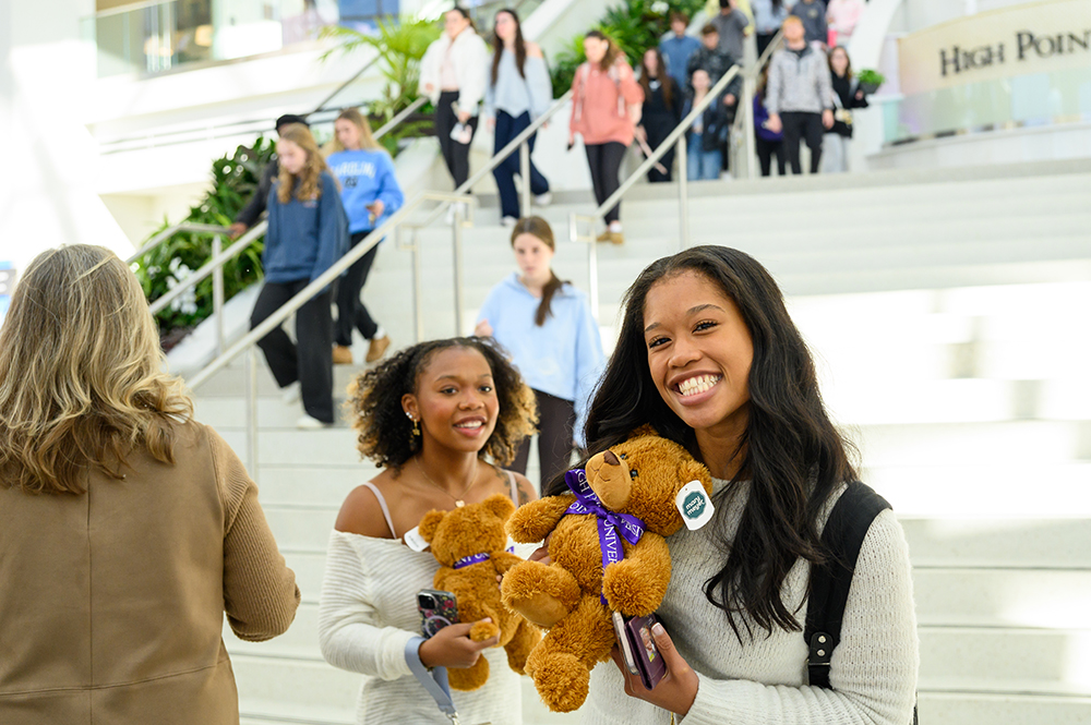 Students smiled and hugged their teddy bear.