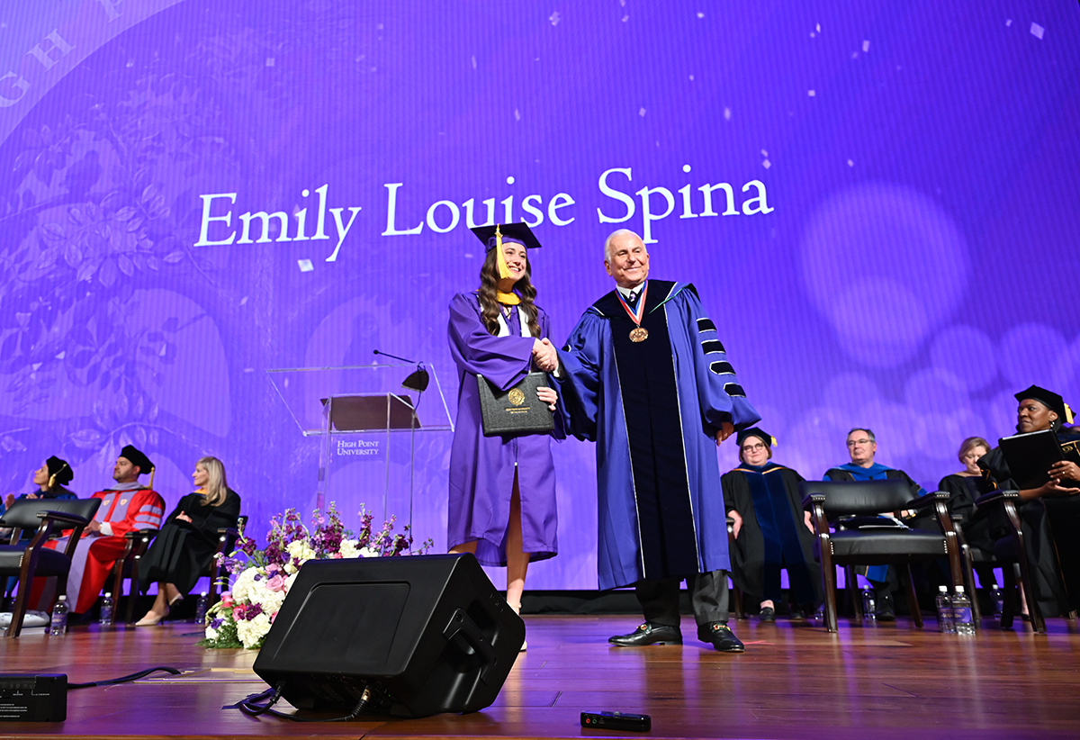 A new graduate with Dr. Qubein after she crossed the stage to receive her degree.