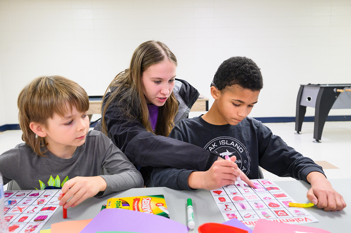 HPU student Alanah Walsh helped two boys with their bingo games.
