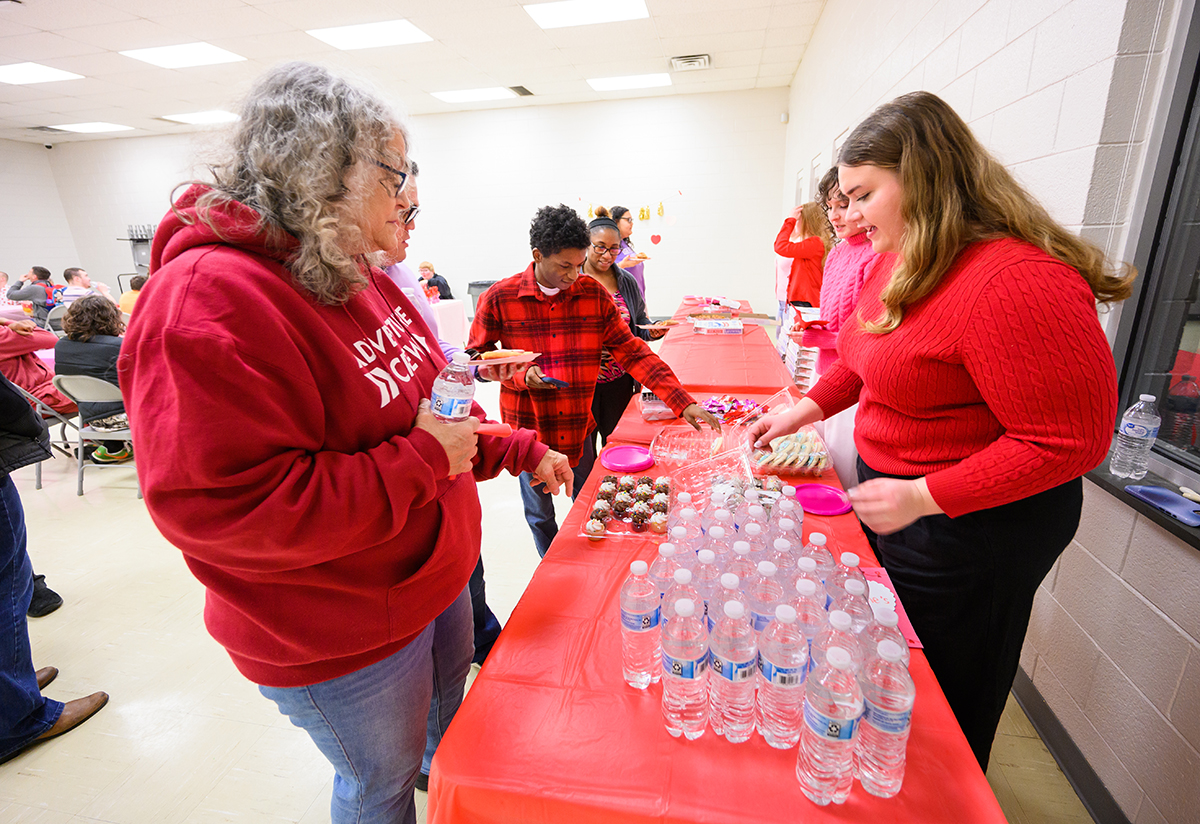 Pictured at right were HPU students Larissa Paddock and Kristina Parimucha as they served snacks to dance participants. 
