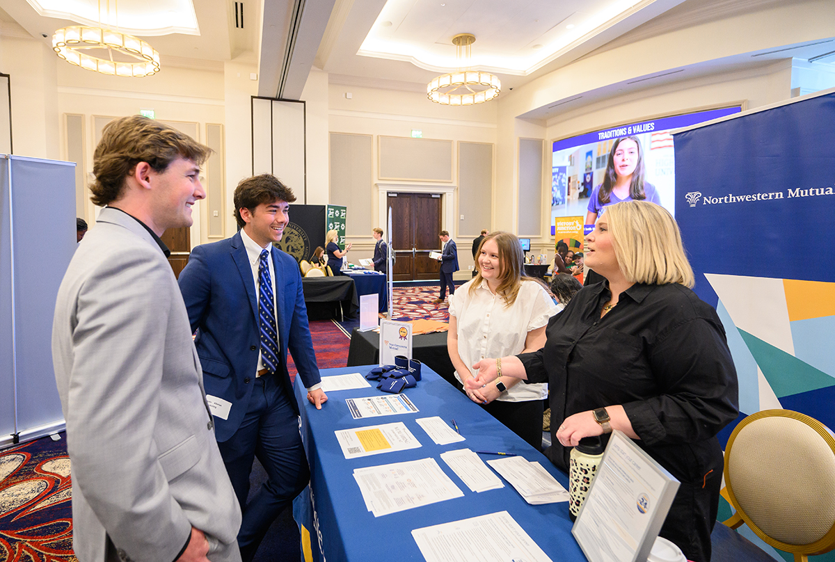 Students Wyatt Cosgriff and Nate Alleman smiled as they talked with recruiters from Northwestern Mutual, a financial services company.