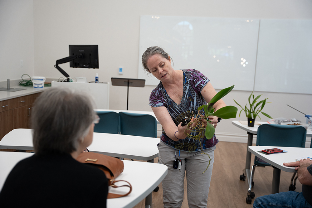 Pictured is Martha George, a member of the Triad Orchard Society, who led workshops on repotting orchids at the 2024 orchid show. Attendees at this year’s event can learn the essentials of potting, mounting and caring for orchids during orchid workshops. 