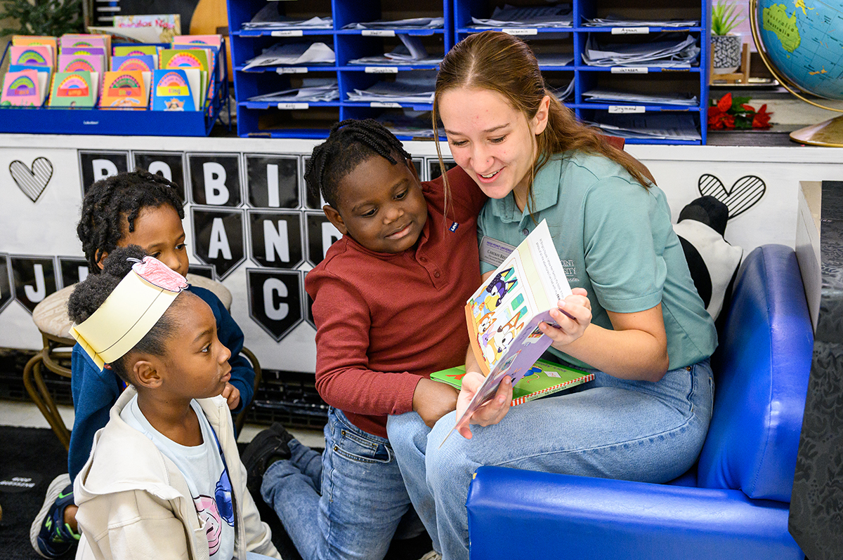Cameran Brick, a freshman elementary education major from Southington, Connecticut, smiled as she read to kindergarten students at Northwood Elementary School in High Point.