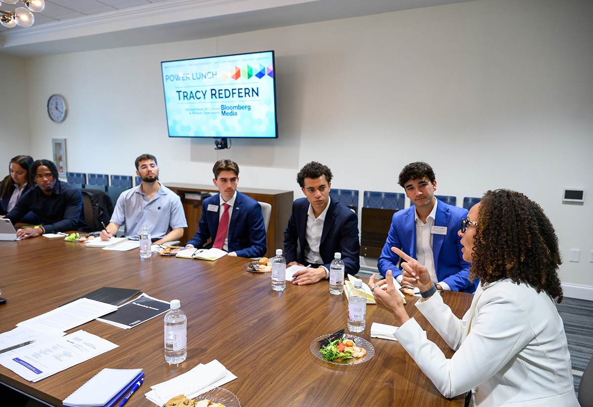 Students listened attentively as they shared lunch with Redfern.