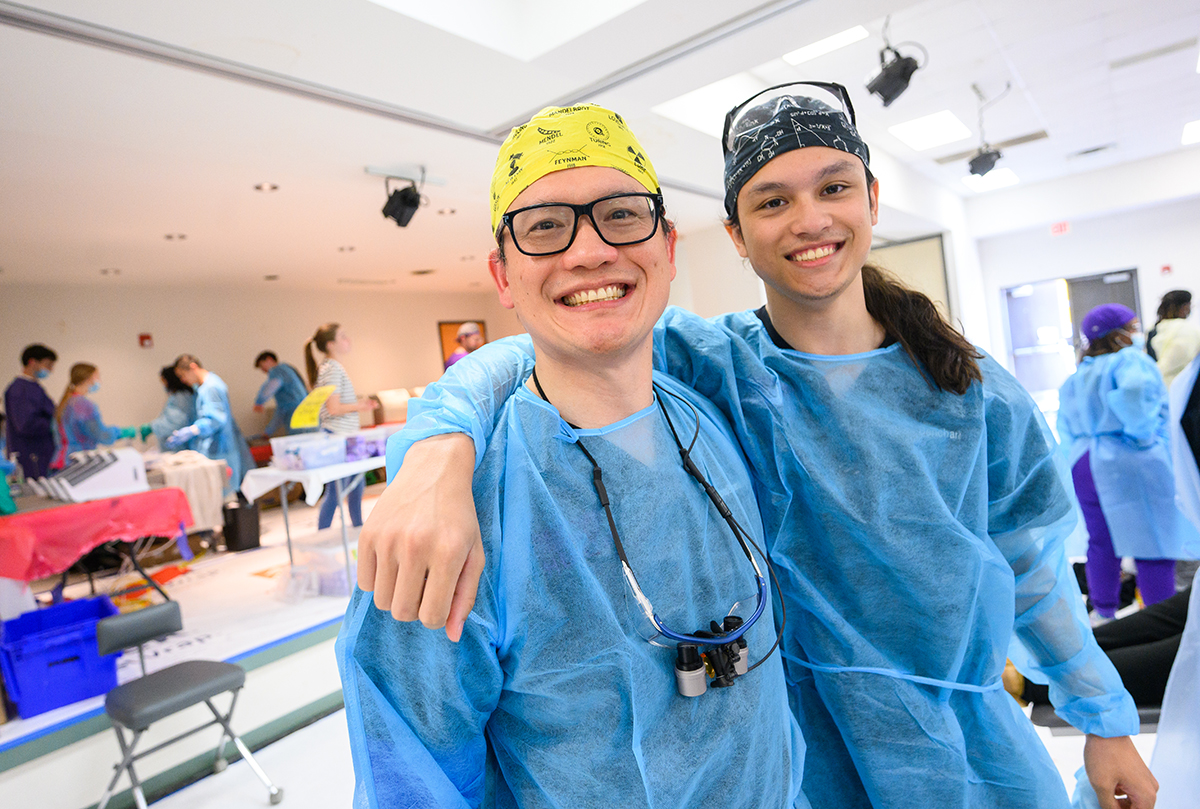 Dr. Sompop Bencharit, HPU's Workman School of Dental Medicine's chief innovation officer and associate dean for innovation, and his son Niko Bencharit, smiled as they provided dental treatment during the NC MOM Clinic.