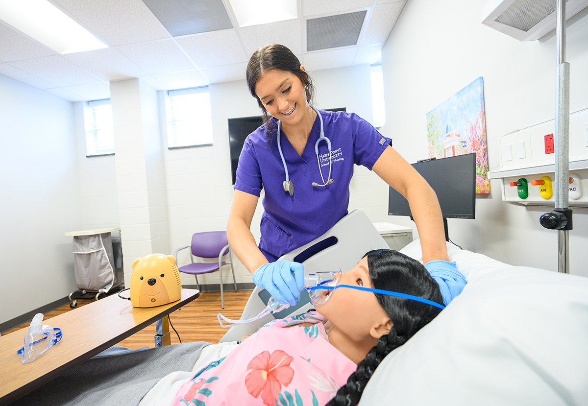 Madi Kee, who is pictured in a pediatric simulation lab, says she has lined up her dream job as a nurse in the pediatric emergency department at Atrium Health Levine Children’s Brenner Children’s Hospital.