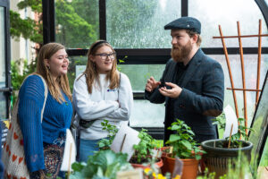 History major Quinn Fergusson, right, shares his research about medieval and Early Modern medicine with other students.