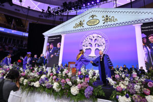 Dr. Qubein, right, shook every student’s hand as they crossed the stage to receive her diploma.