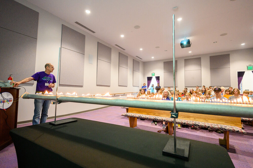 Jeff Regester, retired HPU instructor of physics and astronomy, explained dancing flames to an audience during flame tube shows at SciQuest.