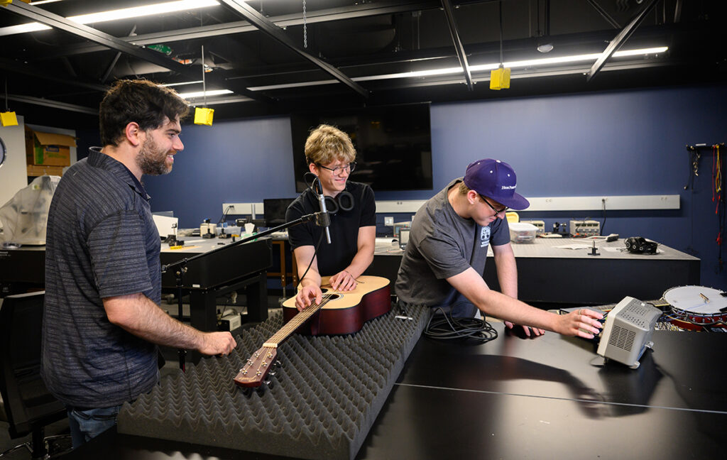 Dr. Eric Rokni, assistant professor of physics, works on musical acoustics research with physics majors Josh Elbertson, center, and Zachary Ready.