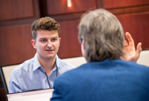 Trent Golini, a senior finance major from Boston, Massachusetts, discussed his research on how artificial intelligence impacts the stock market.