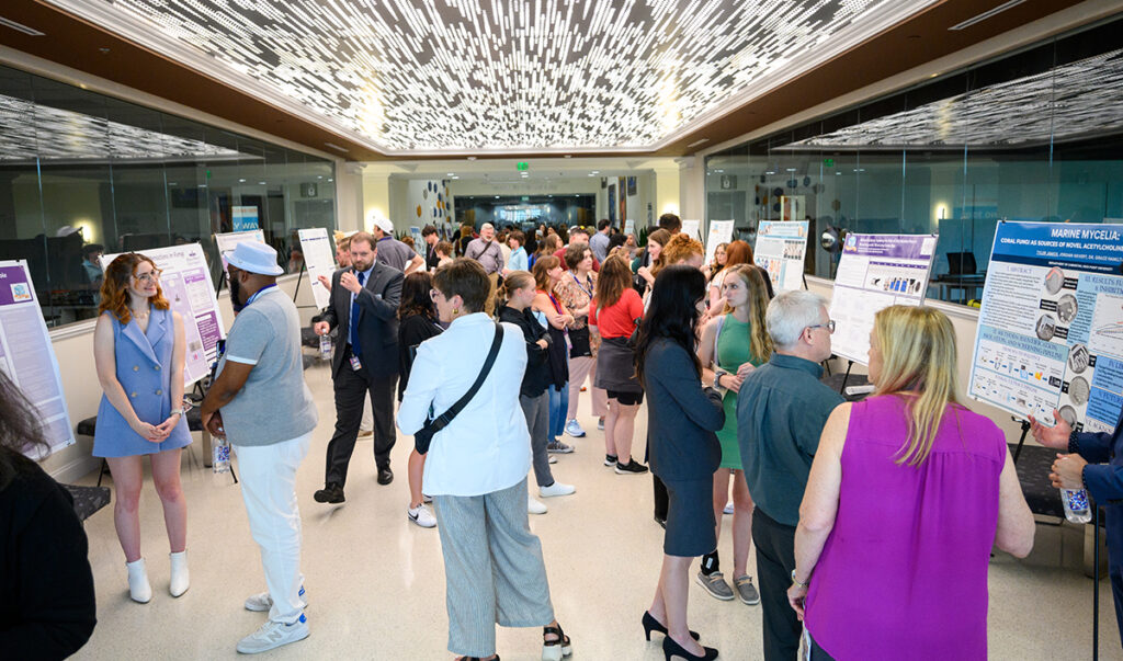 Students in the Summer Undergraduate Research Program in the Sciences presented their research to students, staff, faculty and high school counselors in the Wanek School of Natural Sciences’ lobby and the Culp Planetarium.