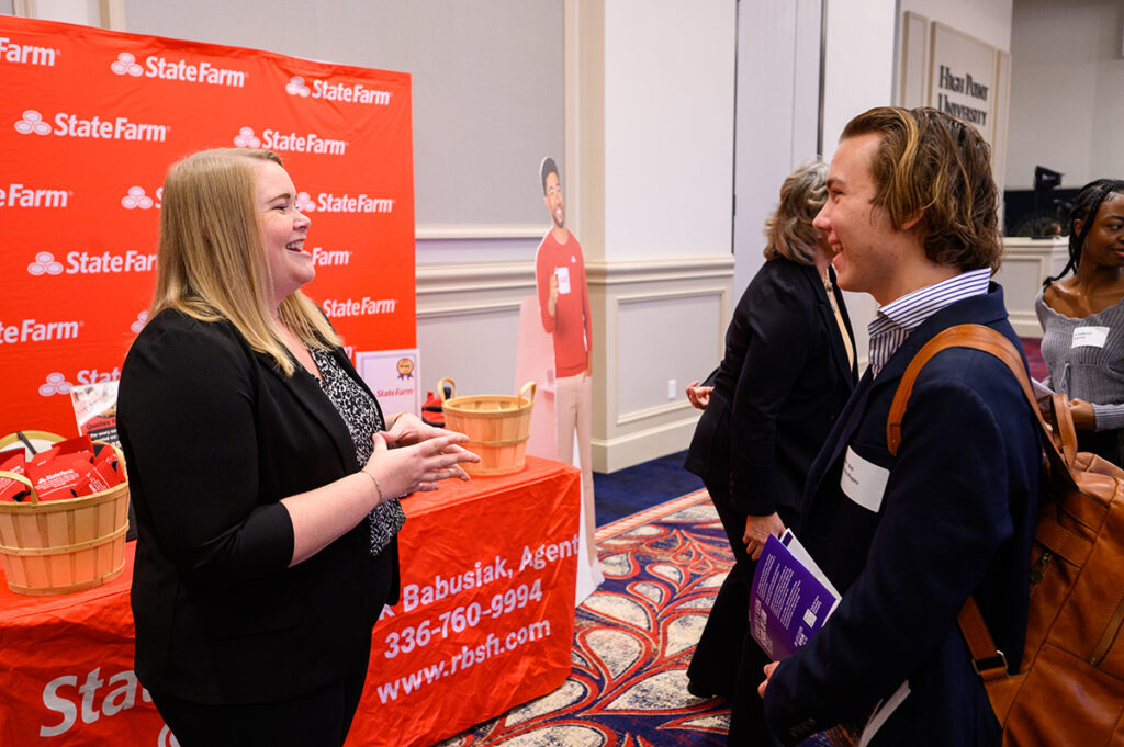 A State Farm recruiter chats with an HPU student about internship and job opportunities.