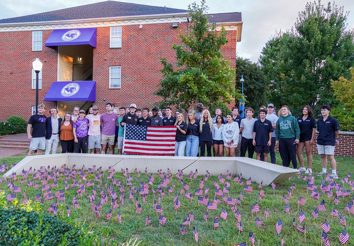 A group of HPU students paused after planting American flags at Patriots Plaza.