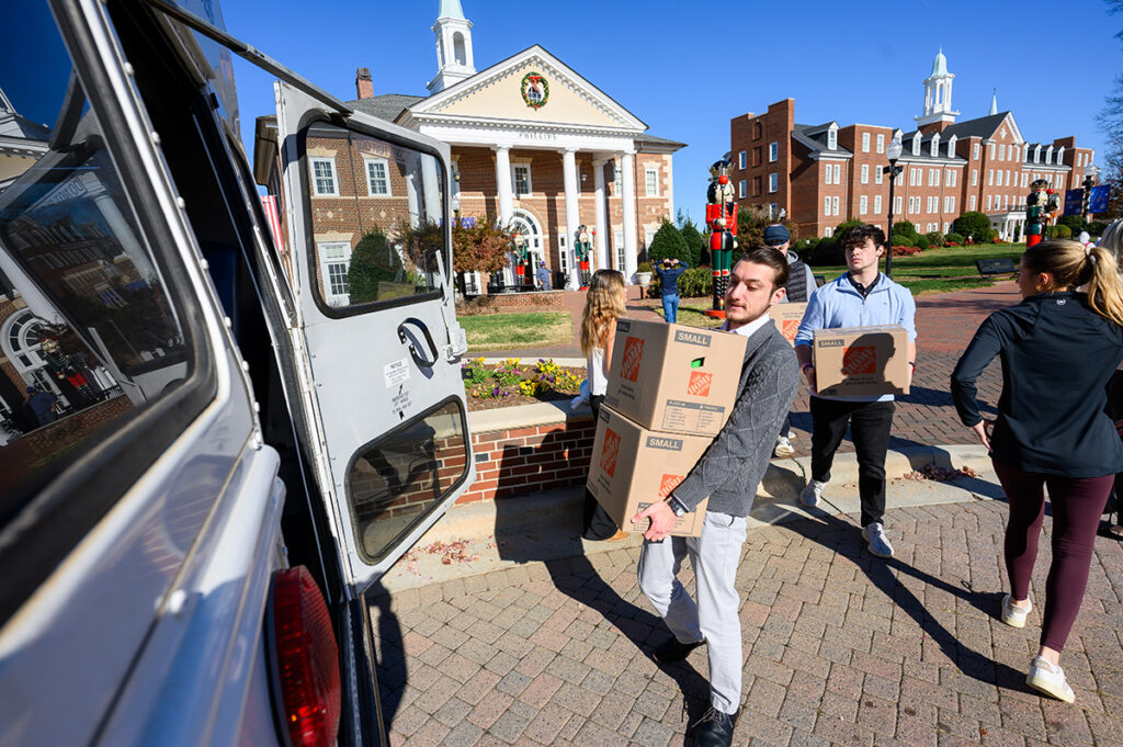 Lazaridis, a senior sales major with a minor in economics, carried two boxes filled with Thanksgiving food. Lazaridis is originally from Greece and grew up in South Hamilton, Massachusetts.