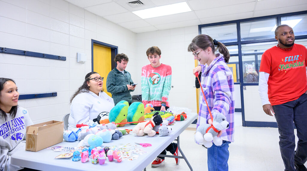 HPU students Victoria Robinson, Madison Kattke, James Wallace and Robert Wallace, staffed the table where bingo winners picked prizes.