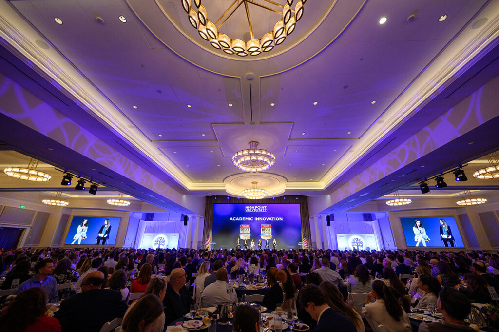 Hundreds of guests attended the Presidential Scholars dinner and listened as HPU alumni who are leading successful careers with top companies shared their HPU experiences that helped them get there. From left were Cameron Scott, ’17, Wasserman Baseball; Carly Garr, ’19, Universal Destinations; Emerson Heckler, ’24, Wake Forest School of Medicine; Emmy Beck-Aden, ’22, NBC News; Jack Lasalla, ’24, BNY; and Julia Segalla, ’24, ’23, Johnson and Johnson.