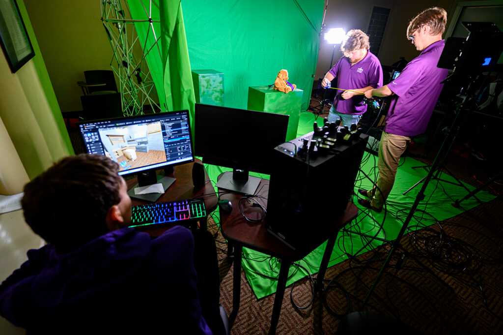 Research at HPU spans beyond majors in the sciences, too. As part of a research project, game design and media production students are pictured using a virtual production studio in the Nido R. Qubein School of Communication to produce a fire safety Public Service Announcement (PSA) that could be used for film and television. Pictured are students Austin Edwards, left, Shane Cooper, center, and Jacob Drew, setting up the virtual production studio.